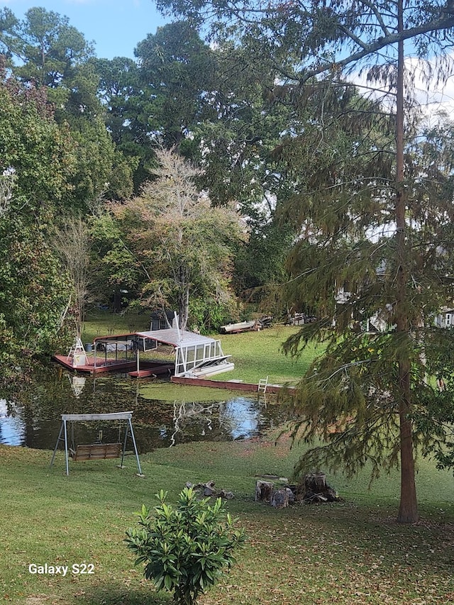 exterior space featuring a lawn and a water view