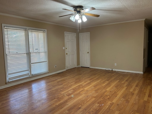 unfurnished room featuring light hardwood / wood-style floors, a textured ceiling, ceiling fan, and ornamental molding