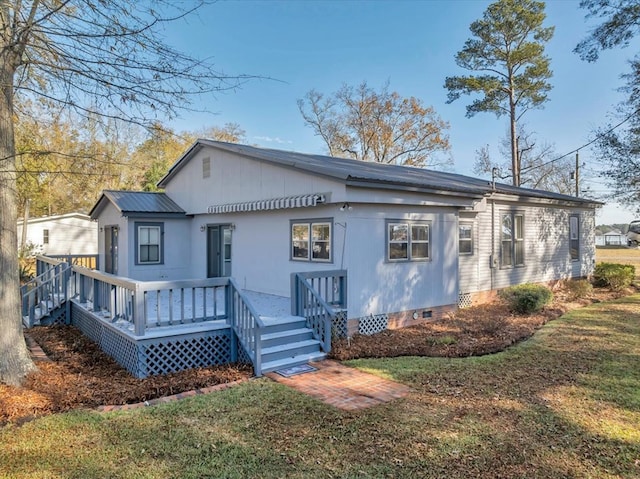 rear view of property with a lawn