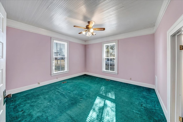 empty room with dark carpet, crown molding, and a healthy amount of sunlight