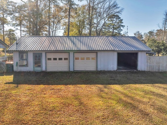 garage featuring cooling unit and a lawn