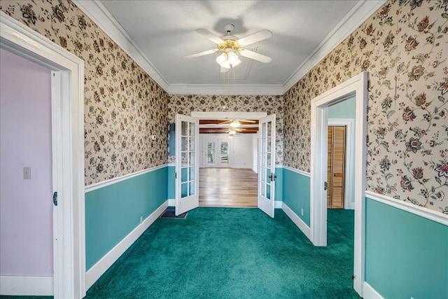 spare room featuring ceiling fan, ornamental molding, dark carpet, and french doors