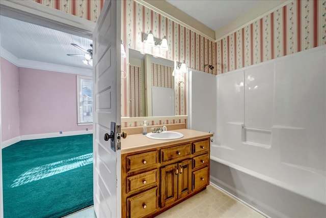 bathroom with vanity, washtub / shower combination, and ornamental molding