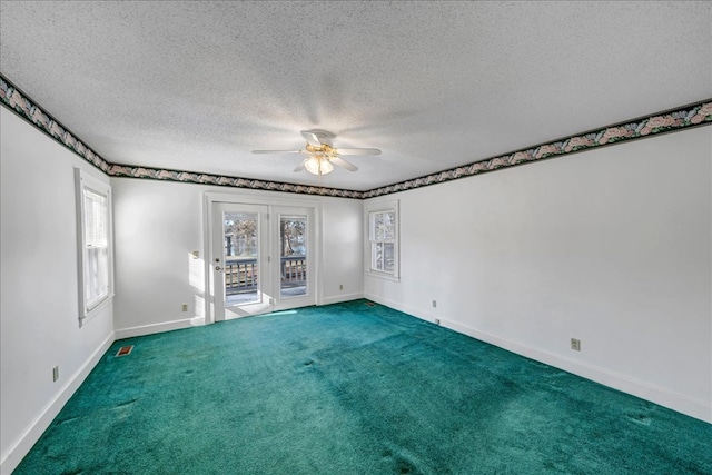 spare room featuring ceiling fan, a textured ceiling, and carpet floors