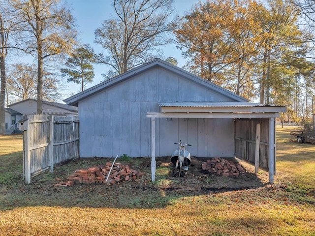 view of property exterior with a lawn and an outdoor structure