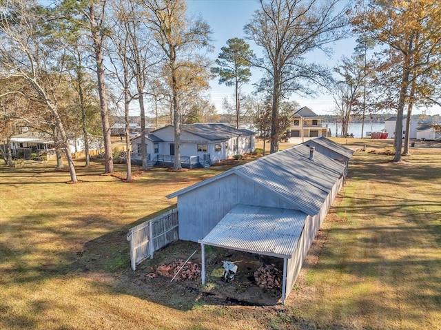 view of yard with a water view and an outbuilding