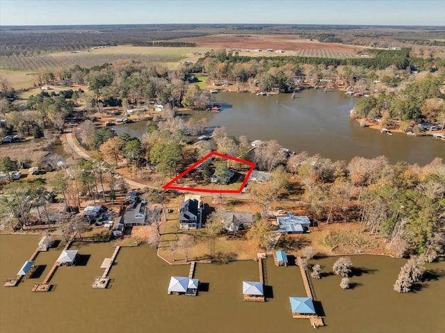 birds eye view of property featuring a rural view and a water view