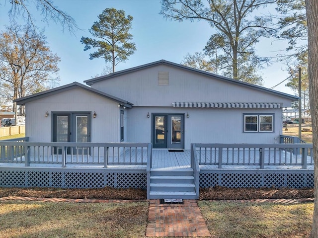 back of house featuring a wooden deck