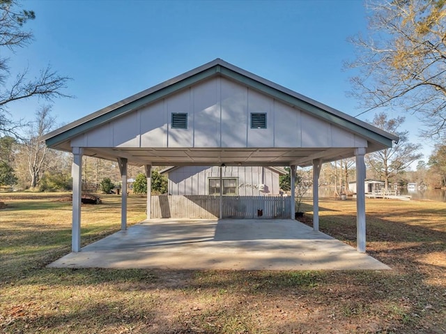 view of parking / parking lot with a yard and a carport