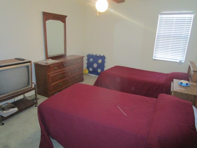 bedroom featuring ceiling fan and light colored carpet