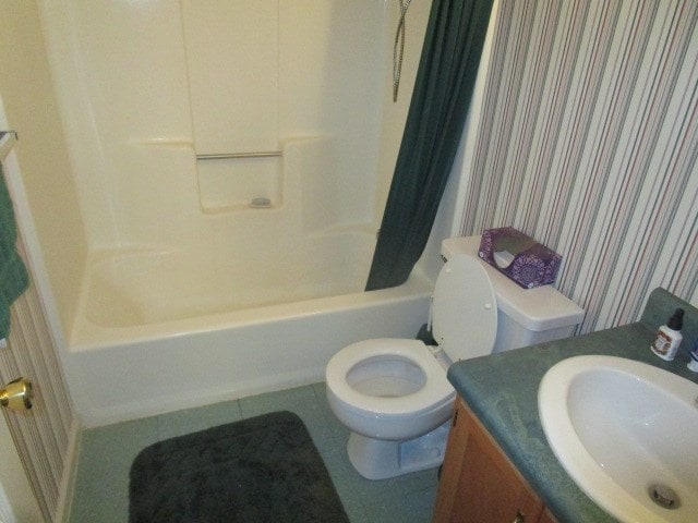 bathroom featuring toilet, wallpapered walls, shower / bath combo, and vanity