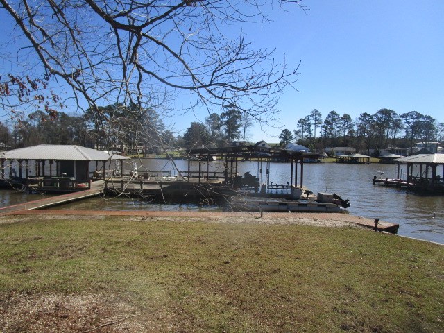 dock area featuring a yard and a water view