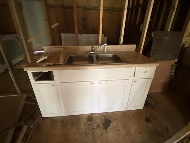 interior space featuring sink and white cabinetry