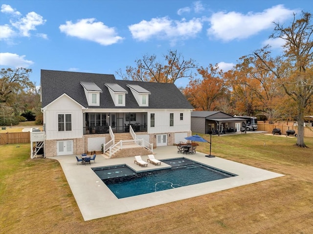 rear view of property with a patio area, a fenced in pool, and a lawn