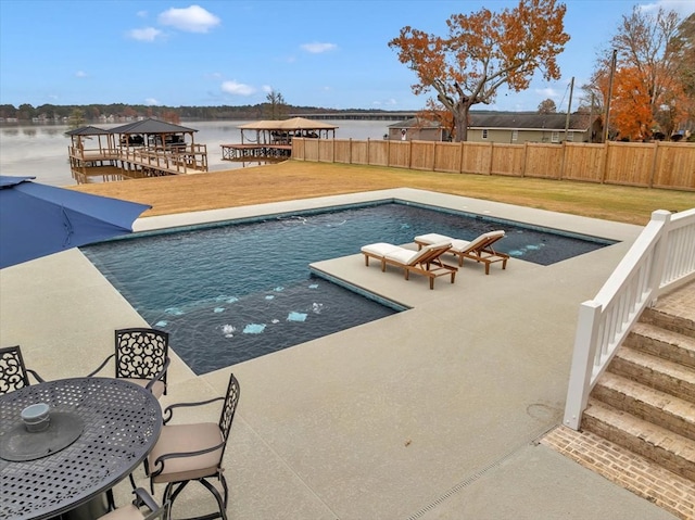 view of swimming pool featuring a lawn, a gazebo, a patio area, and a water view