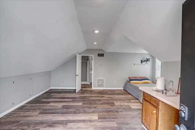 bedroom with sink, vaulted ceiling, and dark hardwood / wood-style floors