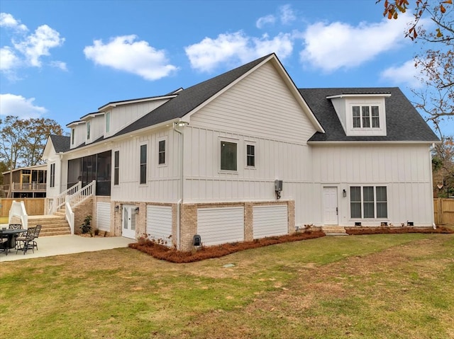 back of property featuring a sunroom, a patio area, and a yard