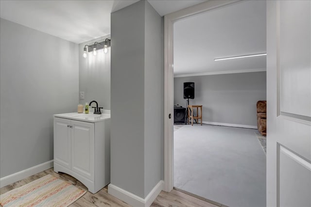 bathroom with hardwood / wood-style floors and vanity