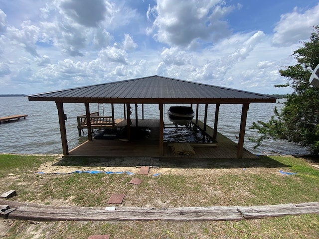 dock area featuring boat lift and a water view