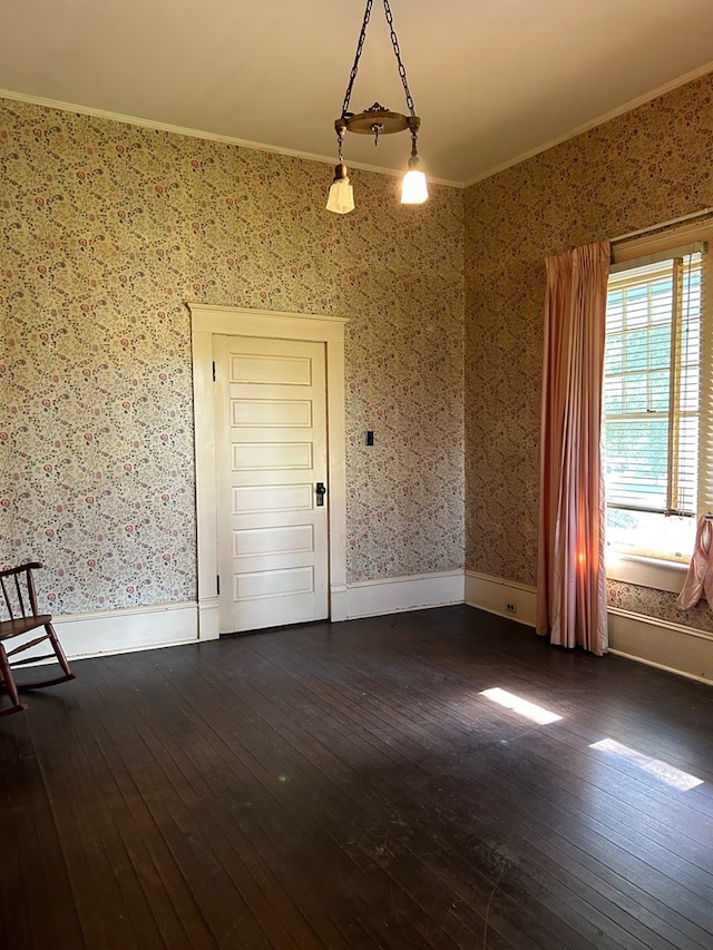 spare room with dark hardwood / wood-style floors and ornamental molding