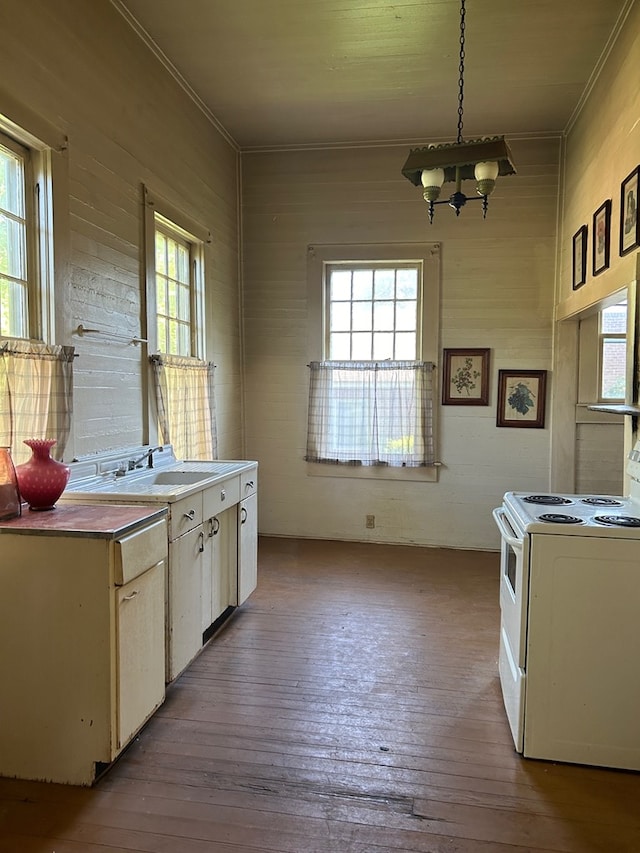 kitchen featuring sink, light hardwood / wood-style floors, white range with electric stovetop, and hanging light fixtures