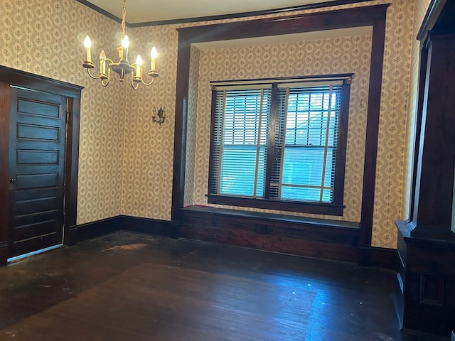 unfurnished dining area with dark hardwood / wood-style flooring, a chandelier, and ornamental molding