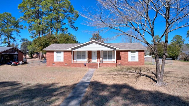 ranch-style home with a front lawn