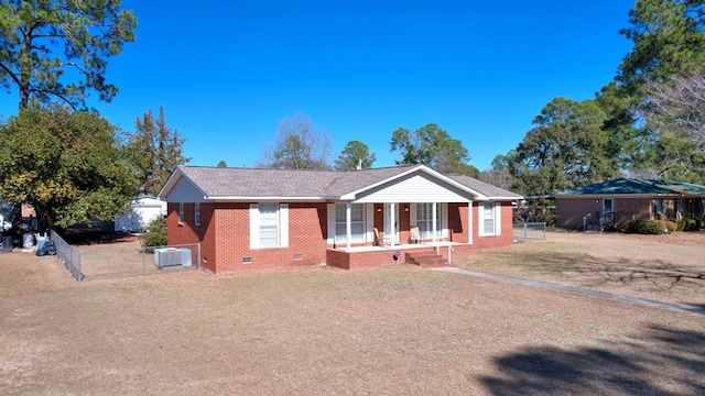 ranch-style house with a porch and central AC unit