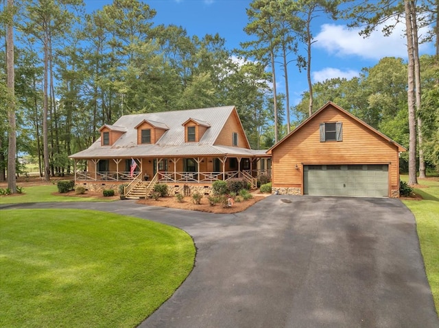 view of front of property with a front yard, a porch, and a garage