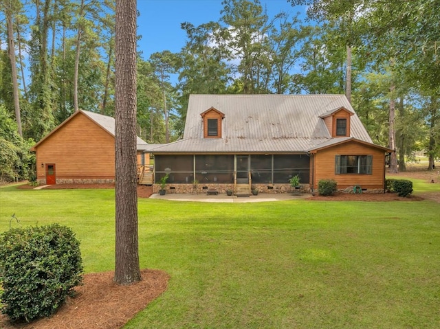 back of house featuring a sunroom and a yard