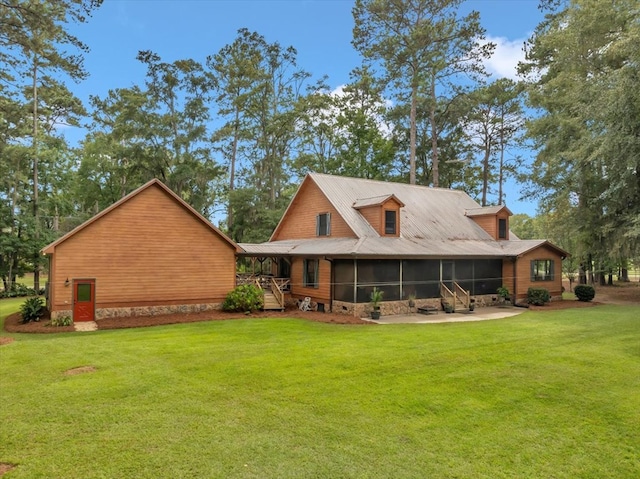 rear view of house with a sunroom and a lawn