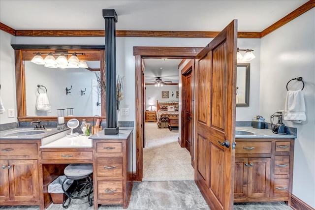 bathroom with ceiling fan, vanity, and ornamental molding