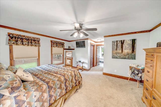 carpeted bedroom with ceiling fan and ornamental molding