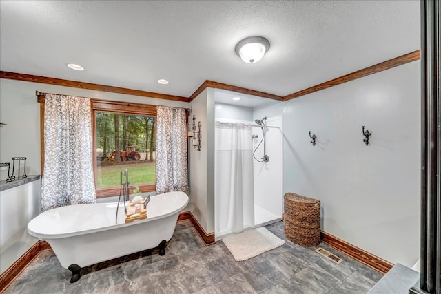 bathroom featuring ornamental molding, a textured ceiling, and shower with separate bathtub