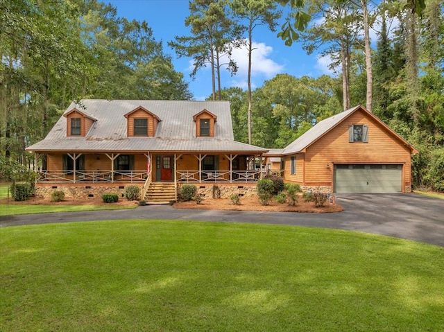 view of front facade with a garage, covered porch, and a front yard