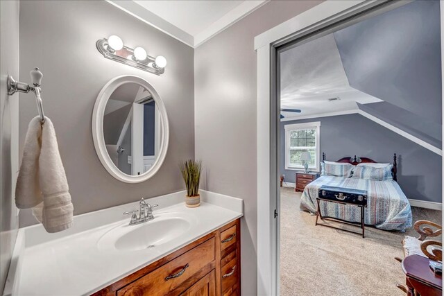 bathroom featuring lofted ceiling, vanity, and crown molding