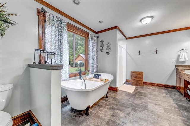 bathroom with vanity, a bathtub, ornamental molding, and toilet