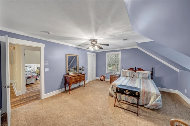 bedroom with ceiling fan, lofted ceiling, and carpet floors