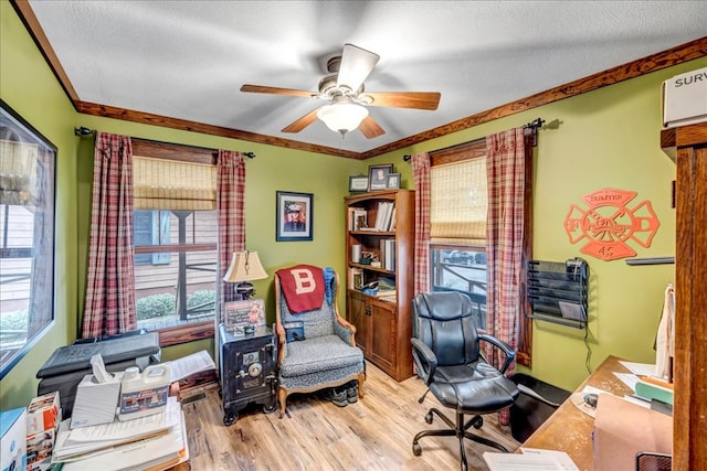 office featuring ceiling fan, crown molding, light hardwood / wood-style floors, and a textured ceiling