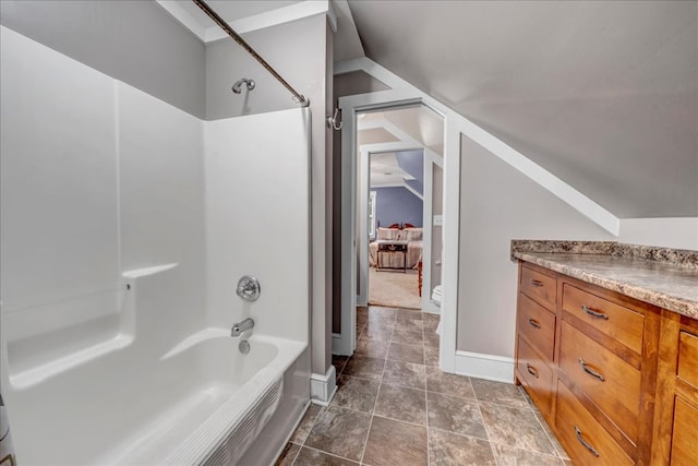 full bathroom with toilet, vaulted ceiling, bathtub / shower combination, and vanity