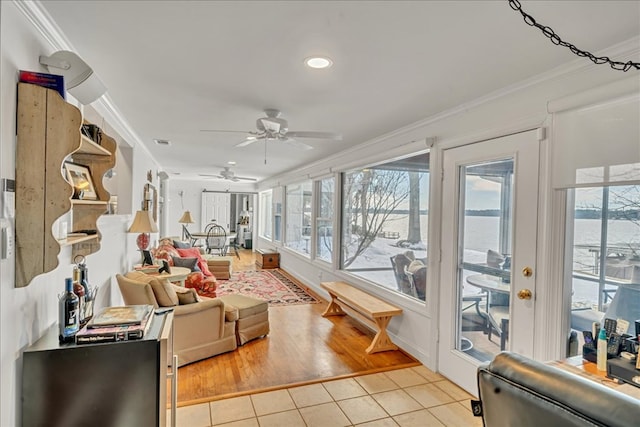 living room featuring light tile patterned floors, visible vents, and ornamental molding