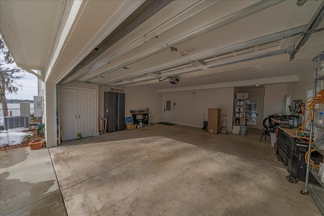 garage with a garage door opener and cooling unit