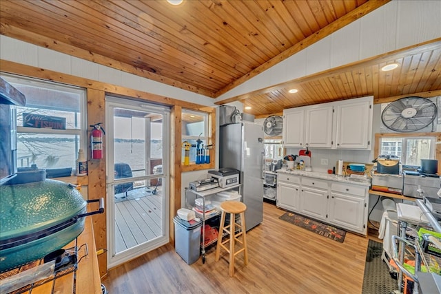 kitchen with freestanding refrigerator, wood ceiling, white cabinets, and vaulted ceiling