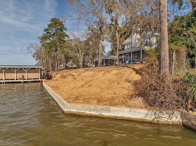 view of yard with a dock and a water view