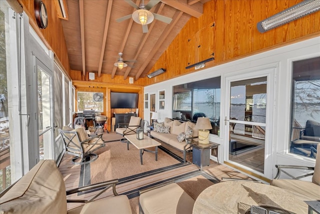 sunroom / solarium featuring vaulted ceiling with beams, wood ceiling, and a ceiling fan