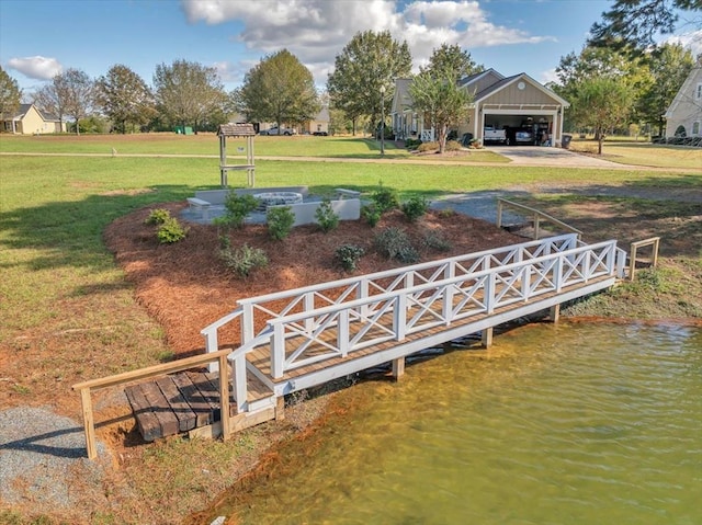 dock area with a water view and a yard