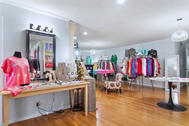 misc room featuring hardwood / wood-style floors, crown molding, and a textured ceiling