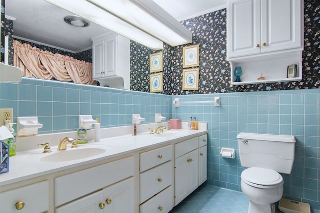 bathroom featuring tile patterned floors, tile walls, toilet, vanity, and ornamental molding