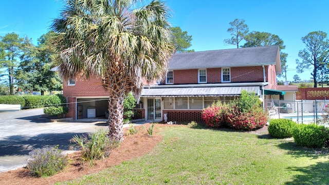 view of front of house with a garage and a front yard