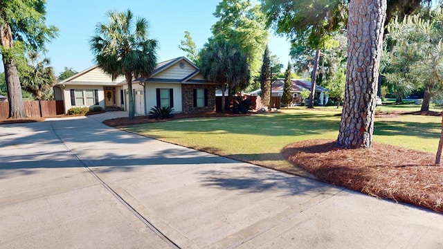 406 Scenic Rt, Cordele, GA 31015 - ranch-style home with driveway, stone siding, a front yard, and fence